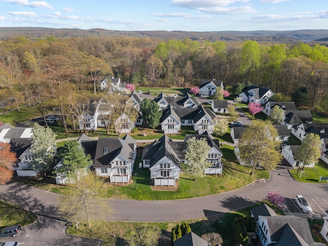 drone / aerial view with a residential view and a wooded view