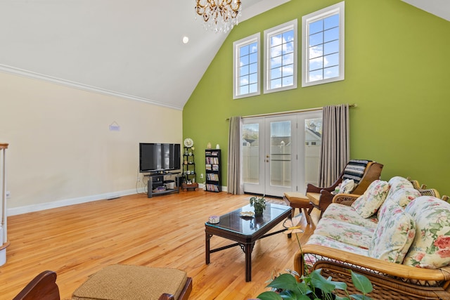 living room featuring french doors, wood finished floors, high vaulted ceiling, baseboards, and a notable chandelier