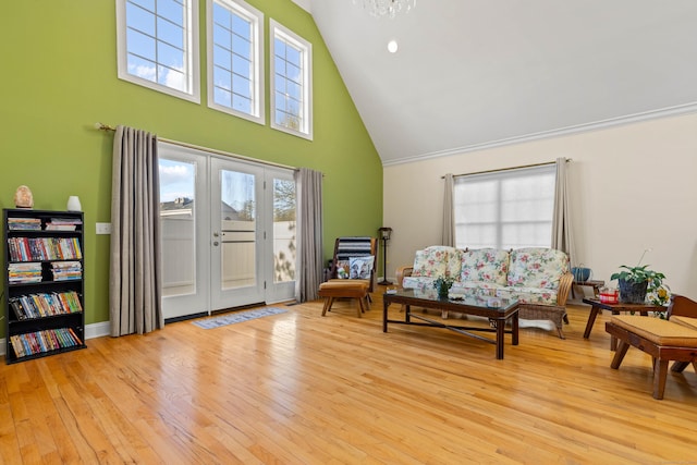living area with high vaulted ceiling, french doors, wood finished floors, and a wealth of natural light