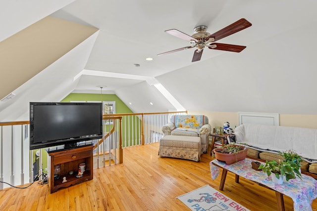living area featuring visible vents, a ceiling fan, wood finished floors, and lofted ceiling