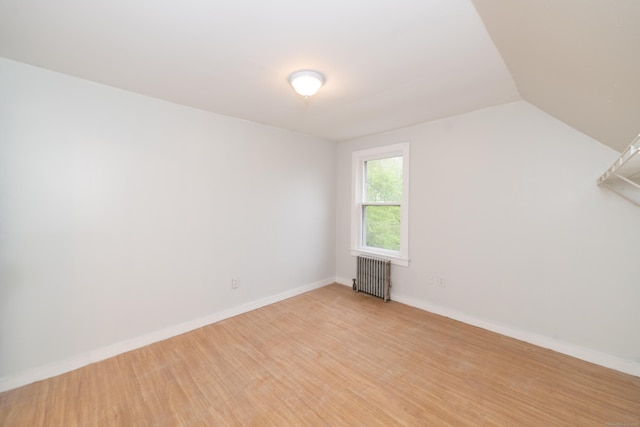 39 Tanner Ave, Norwich, CT 06360 - empty room featuring radiator, light wood-type flooring, baseboards, and lofted ceiling