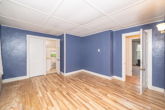 39 Tanner Ave, Norwich, CT 06360 - unfurnished bedroom with wood finished floors, baseboards, and radiator heating unit