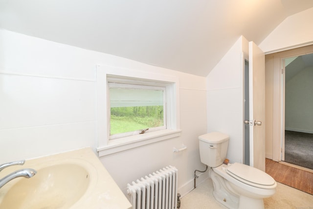 39 Tanner Ave, Norwich, CT 06360 - bathroom with radiator heating unit, vaulted ceiling, a sink, and toilet