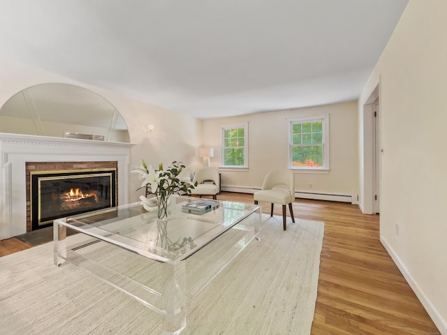 34 Longmeadows Rd, Wilton, CT 06897 - living area featuring baseboard heating, baseboards, a fireplace with flush hearth, wood finished floors, and a baseboard radiator