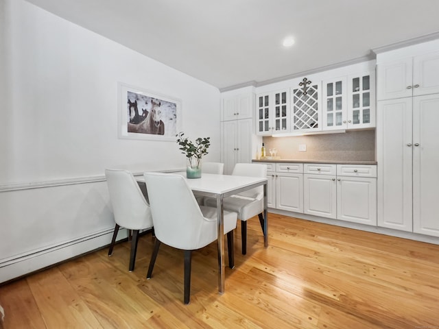 34 Longmeadows Rd, Wilton, CT 06897 - dining area featuring a baseboard radiator, a bar, and light wood finished floors