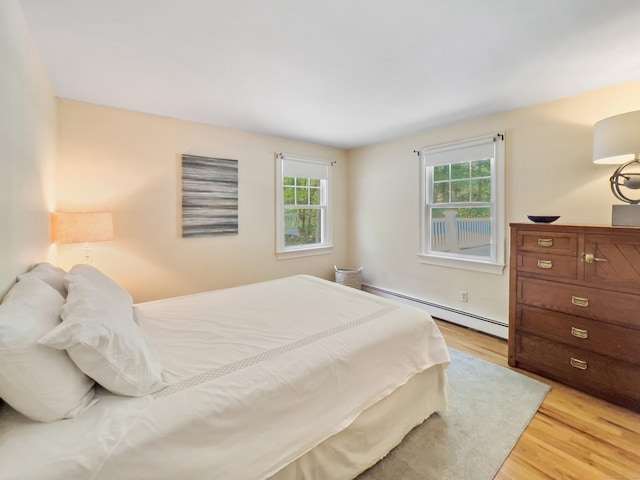34 Longmeadows Rd, Wilton, CT 06897 - bedroom with light wood-style flooring and a baseboard heating unit