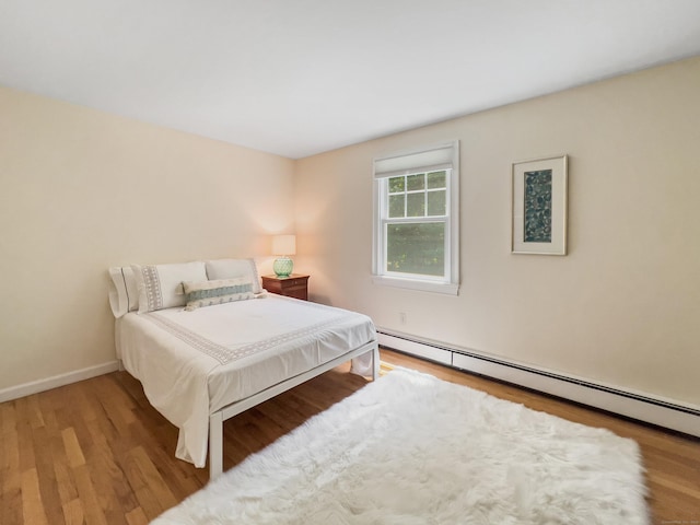 34 Longmeadows Rd, Wilton, CT 06897 - bedroom featuring baseboards, a baseboard radiator, and wood finished floors