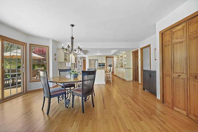 4 Walnut Ridge Rd, New Fairfield, CT 06812 - dining space featuring light wood-style floors, baseboards, and a chandelier
