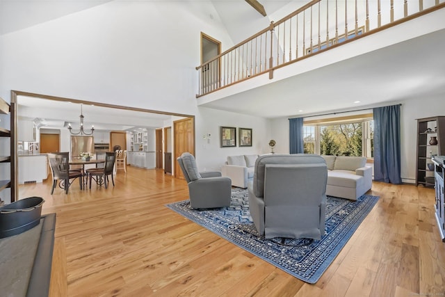4 Walnut Ridge Rd, New Fairfield, CT 06812 - living room featuring an inviting chandelier, wood finished floors, and a towering ceiling