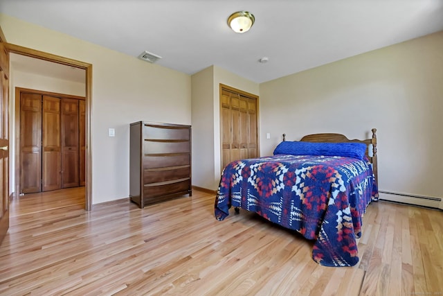 4 Walnut Ridge Rd, New Fairfield, CT 06812 - bedroom with visible vents, a closet, baseboards, light wood-style floors, and a baseboard heating unit