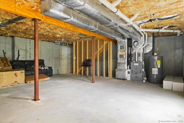 unfinished basement with electric water heater and heating unit