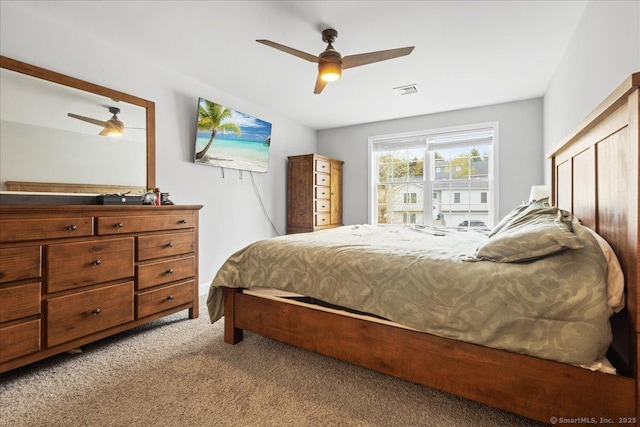 bedroom featuring a ceiling fan, visible vents, and carpet floors