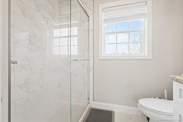 bathroom with baseboards, marble finish floor, vanity, and a shower stall