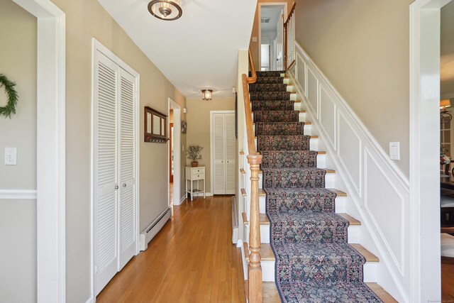 50 Carriage Dr S, Stamford, CT 06902 - stairs featuring baseboard heating and wood finished floors