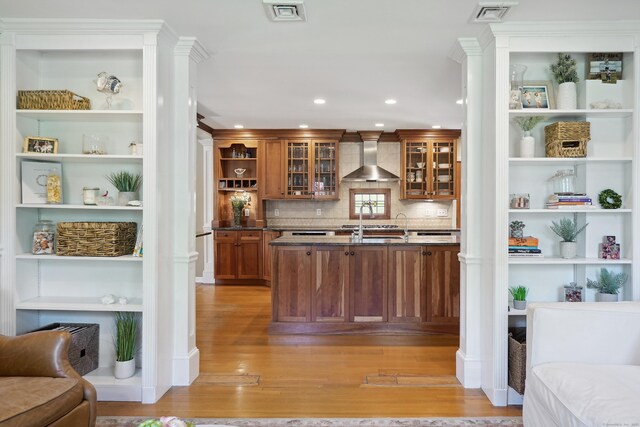 50 Carriage Dr S, Stamford, CT 06902 - bar featuring light wood-style floors, wall chimney exhaust hood, tasteful backsplash, recessed lighting, and a sink
