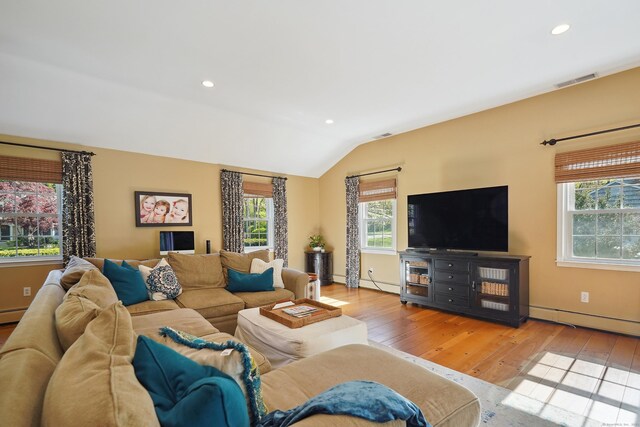 50 Carriage Dr S, Stamford, CT 06902 - living room featuring hardwood / wood-style floors, vaulted ceiling, baseboard heating, and recessed lighting
