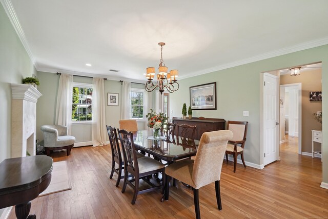 50 Carriage Dr S, Stamford, CT 06902 - dining area featuring a chandelier, light wood-style flooring, crown molding, baseboards, and a baseboard heating unit