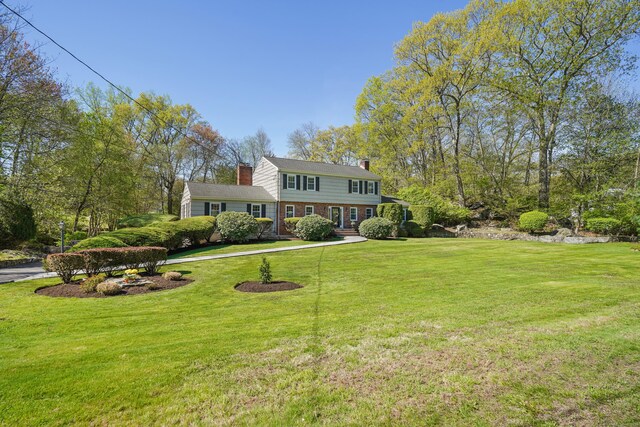 50 Carriage Dr S, Stamford, CT 06902 - view of front facade featuring a chimney and a front lawn