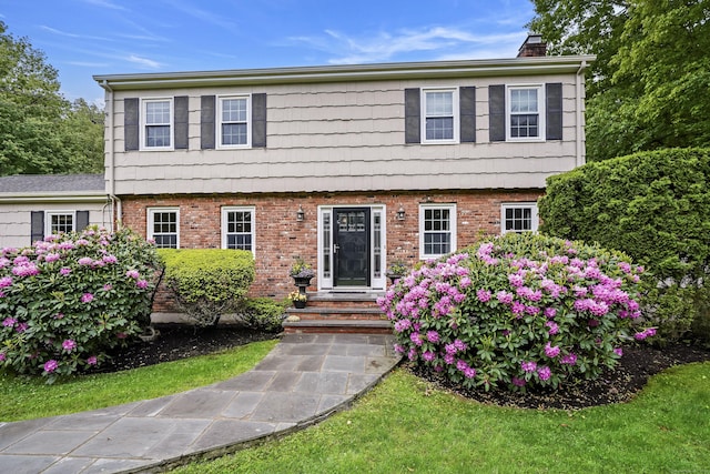 50 Carriage Dr S, Stamford, CT 06902 - colonial inspired home with a chimney and brick siding