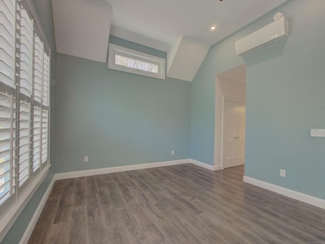 unfurnished room with recessed lighting, baseboards, a wall unit AC, and wood finished floors