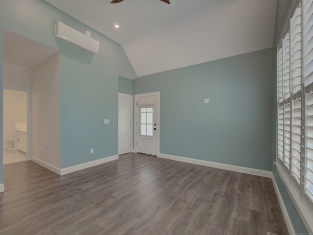 spare room featuring high vaulted ceiling, dark wood finished floors, a ceiling fan, baseboards, and a wall mounted AC