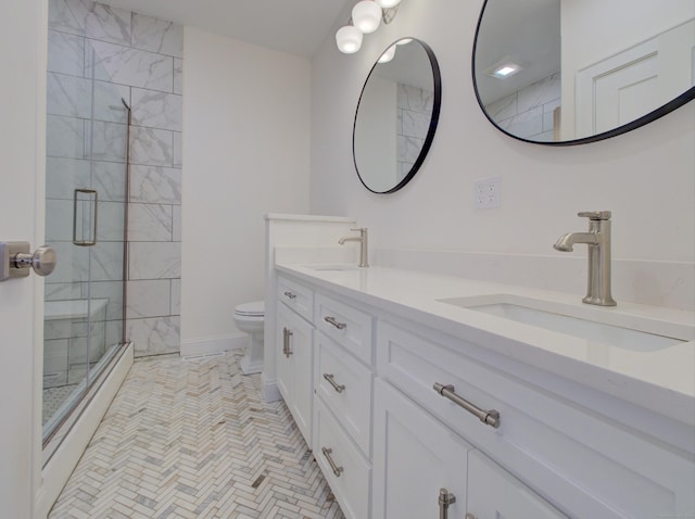 full bathroom with a sink, a tile shower, toilet, and double vanity