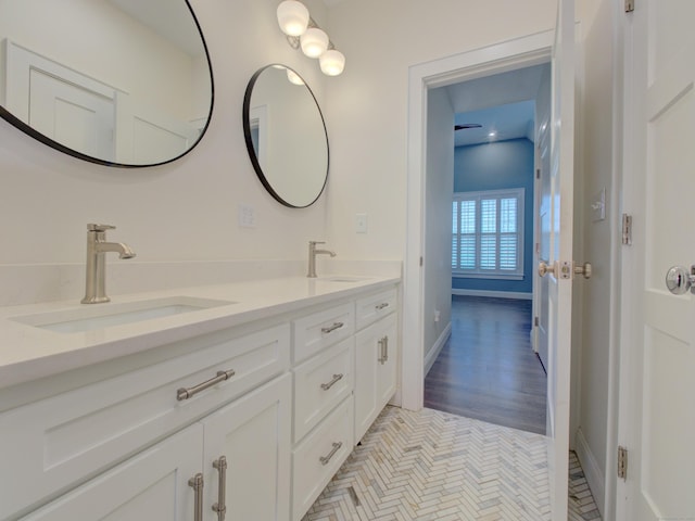 full bath with a sink and double vanity