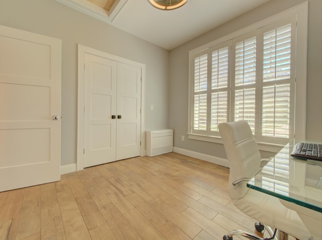 office space featuring baseboards and wood finished floors