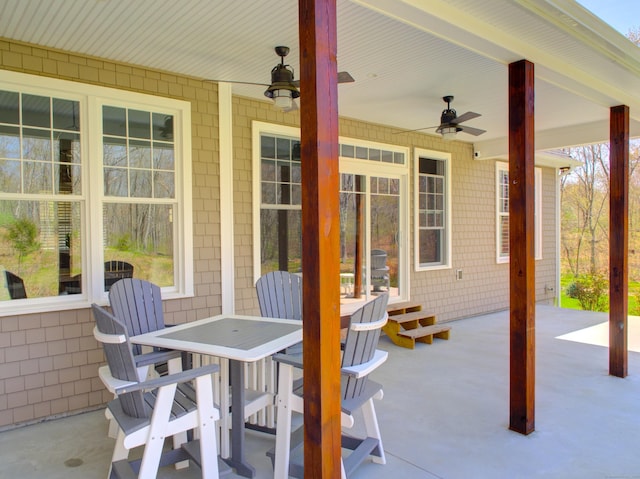 view of patio featuring a ceiling fan and outdoor dining space