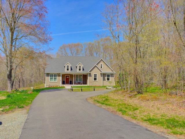cape cod home with covered porch and driveway