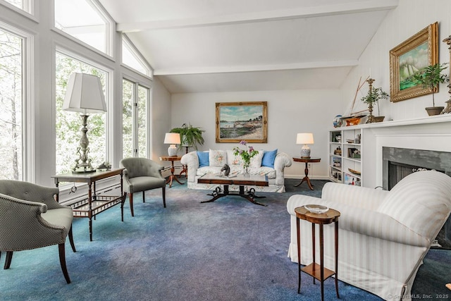 living area featuring carpet floors, baseboards, vaulted ceiling with beams, and a high end fireplace