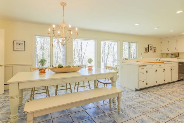 dining area with recessed lighting, a notable chandelier, wainscoting, and light tile patterned floors