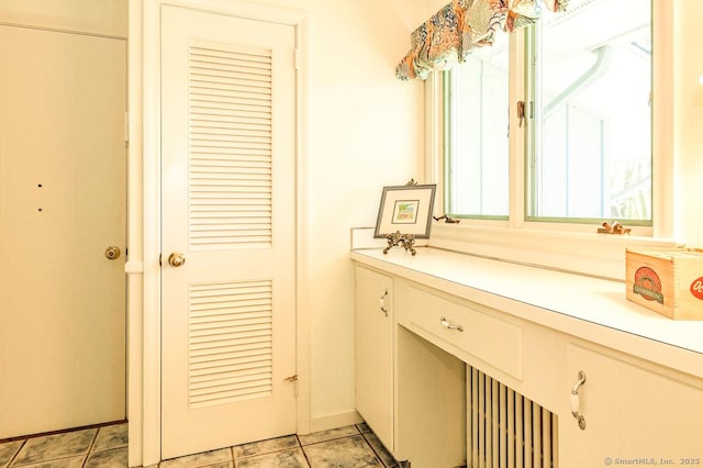 bathroom featuring baseboards and vanity