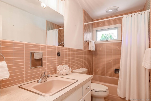 full bathroom featuring decorative backsplash, tile walls, shower / tub combo, vanity, and toilet