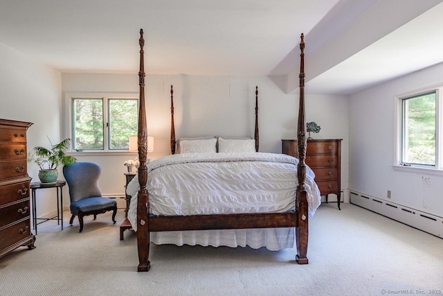 bedroom with a baseboard radiator and light carpet