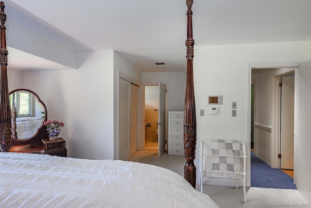 bedroom with visible vents, carpet flooring, and a closet