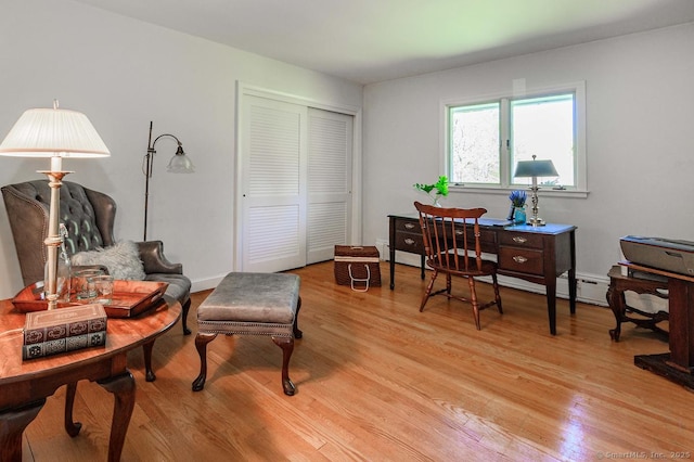 home office featuring light wood-type flooring and a baseboard radiator