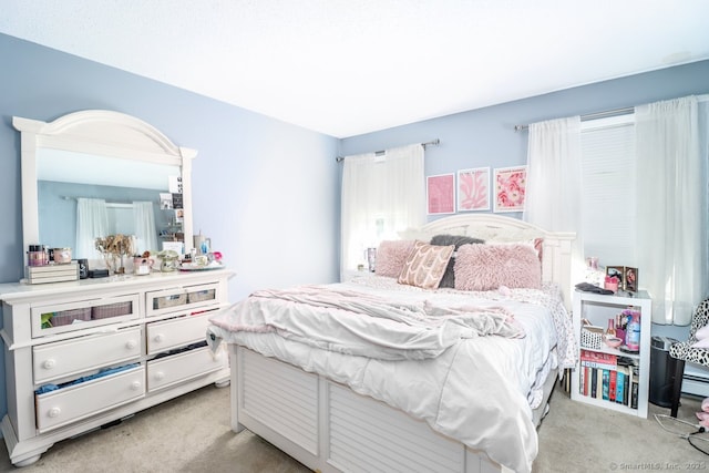 bedroom featuring light colored carpet