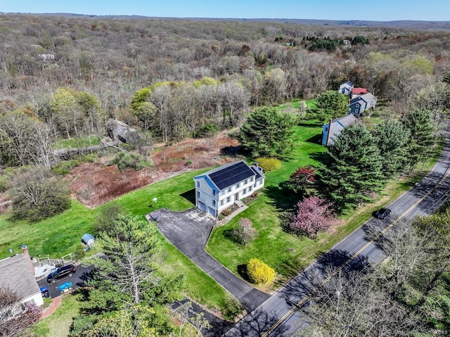 birds eye view of property with a wooded view