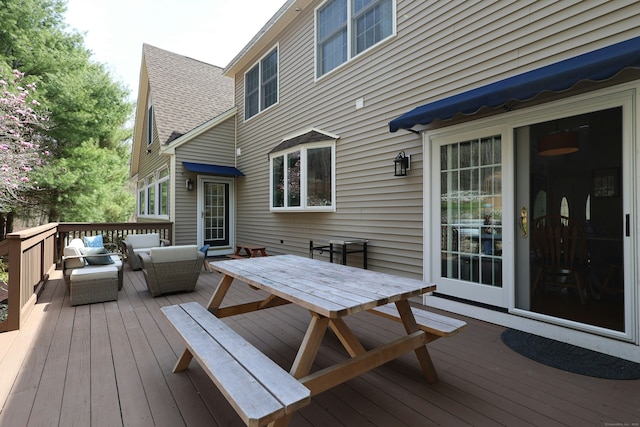 wooden terrace with an outdoor hangout area and outdoor dining space