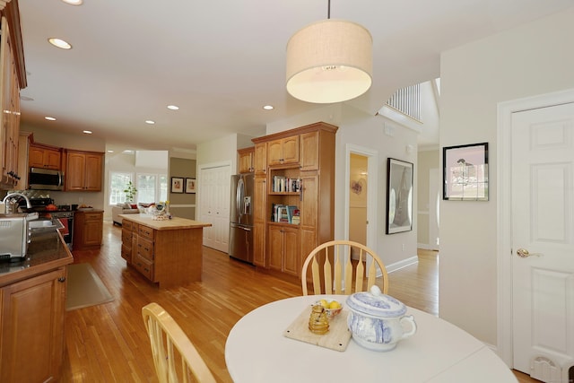 dining space with recessed lighting, baseboards, and light wood-style flooring