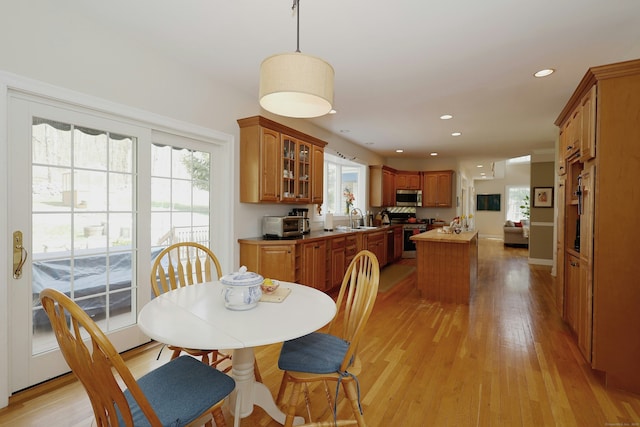 dining area featuring light wood-style floors and recessed lighting