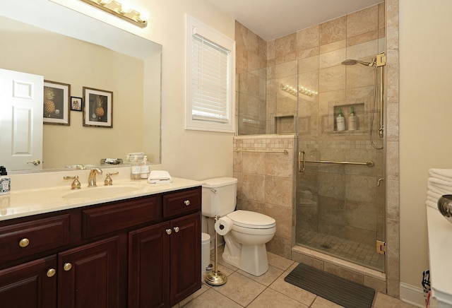 bathroom featuring vanity, toilet, tile patterned flooring, and a stall shower