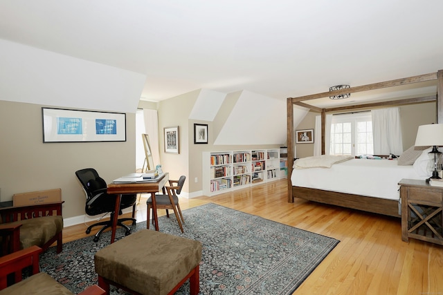 bedroom featuring baseboards and wood finished floors
