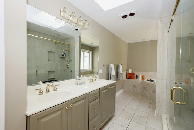 full bath featuring a sink, tile patterned floors, a shower stall, and double vanity