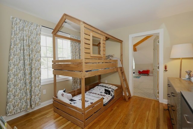 bedroom featuring baseboards and wood finished floors