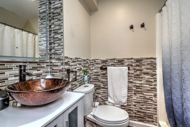 115 W Avon Rd, Farmington, CT 06085 - bathroom featuring toilet, tile walls, wainscoting, and vanity