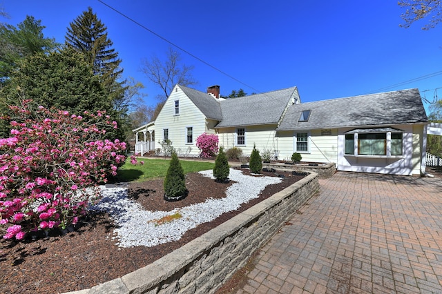 115 W Avon Rd, Farmington, CT 06085 - view of front of property with roof with shingles and a chimney