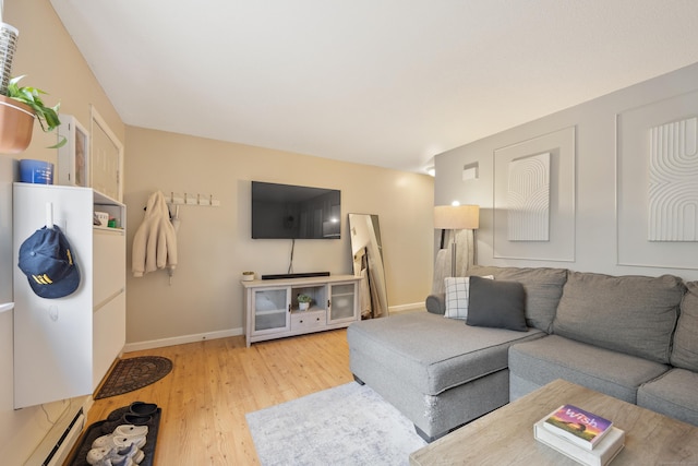 living room with wood finished floors, baseboards, and a baseboard radiator