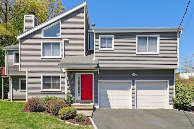 46 Fairway Grn, Fairfield, CT 06825 - view of front of property featuring an attached garage, a chimney, and driveway